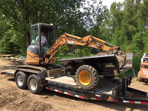 mini excavator pulling forwarder trailer|Pulling a trailer with a Mini Excavator .